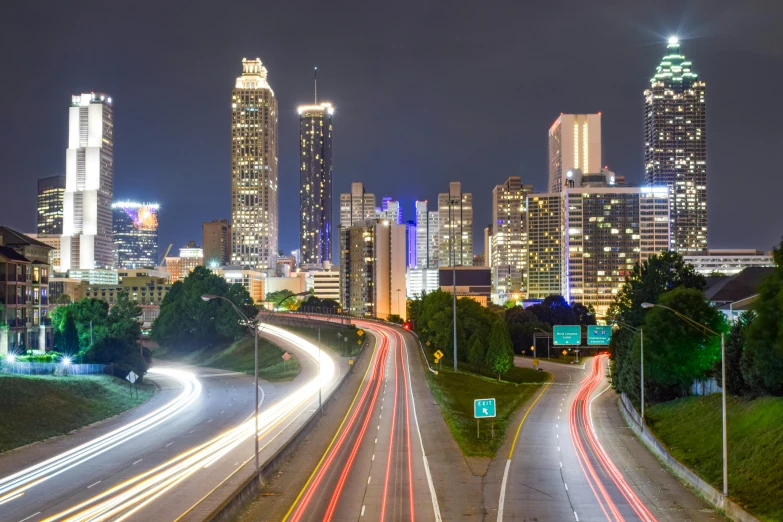 a city street filled with lots of traffic next to tall buildings, a picture, hurufiyya, lush tress made of city lights, 2022 photograph, ultrawide image