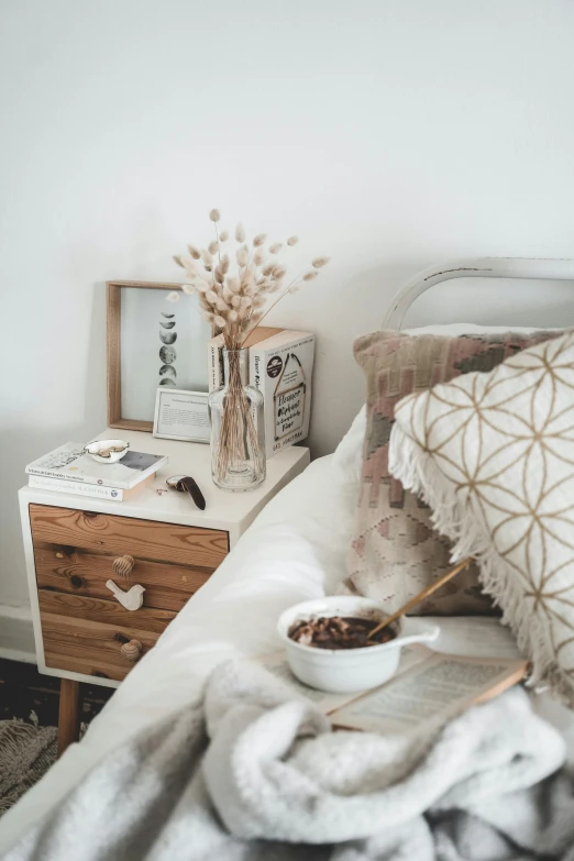 a bed with a bowl of cereal on top of it, inspired by Constantin Hansen, pexels contest winner, boho neutral colors, brown, bedroom, small