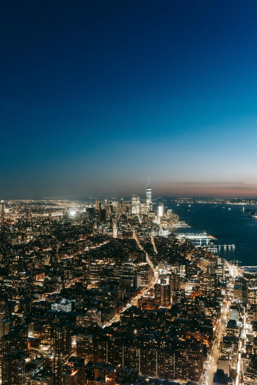 a view of a city at night from the top of a building, unsplash contest winner, hudson river school, 4 k cinematic panoramic view, high res 8k, summer evening, nightlife