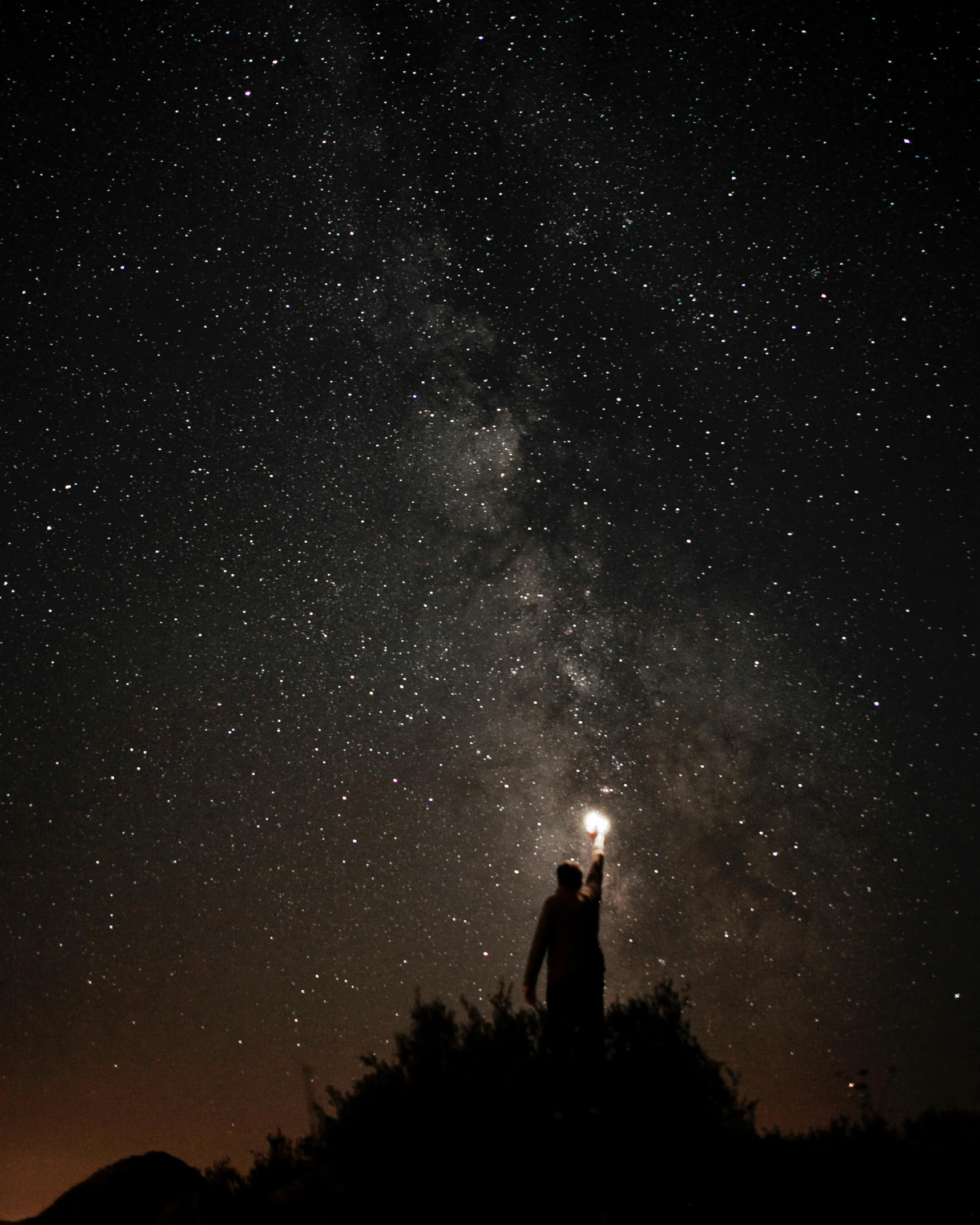 a person standing on top of a hill under a night sky, pexels contest winner, light and space, holding a lantern, profile picture, holding a tiny galaxy, high quality image