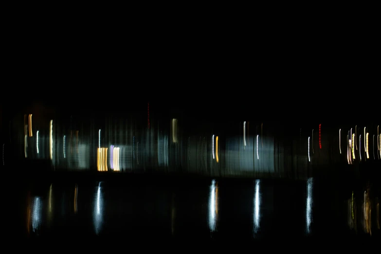 a blurry photo of a city at night, a picture, by Jan Rustem, unsplash, lyrical abstraction, waterline refractions, in a row, docks, minimalist photorealist