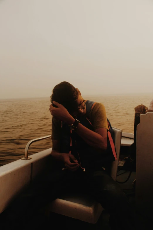 a couple of people that are sitting on a boat, pexels contest winner, romanticism, faded and dusty, head bowed slightly, thick smoke around him, golden hues