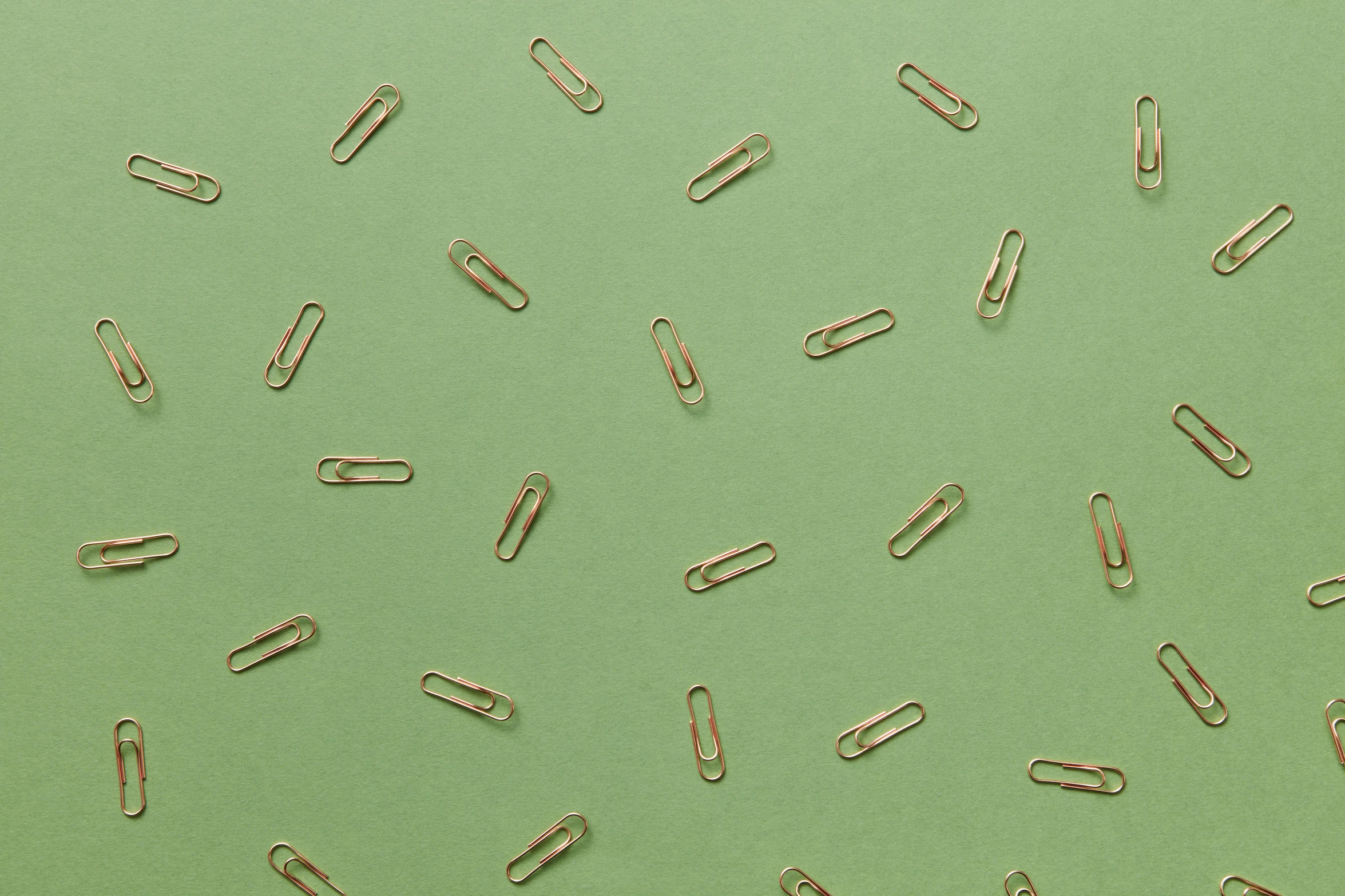 a bunch of paper clips on a green surface, by Emma Andijewska, trending on pexels, computer art, repeating pattern, thin gold details, background image, polka dot