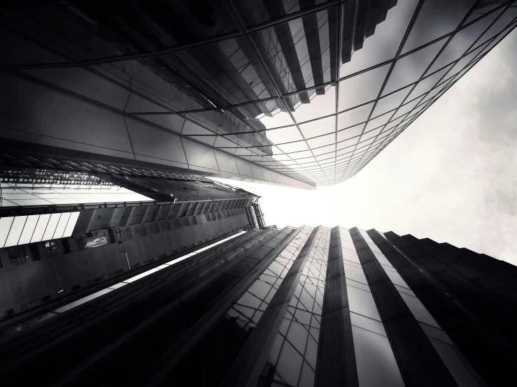 a black and white photo of tall buildings, inspired by Zaha Hadid, unsplash contest winner, epic scale fisheye view, alessio albi, sleek glass buildings, vertical architecture