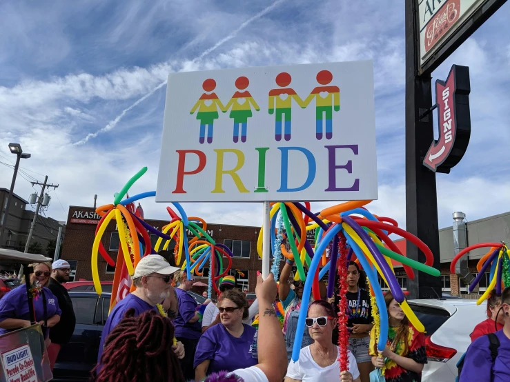 a group of people holding up a pride sign, albuquerque, rainbow tubing, 2019, ballard