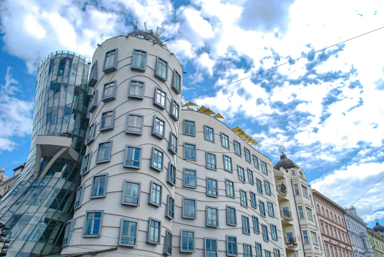 a tall building sitting on the side of a street, inspired by Vladimir Tatlin, pexels contest winner, art nouveau, square, frank gehry, abandoned prague, profile image