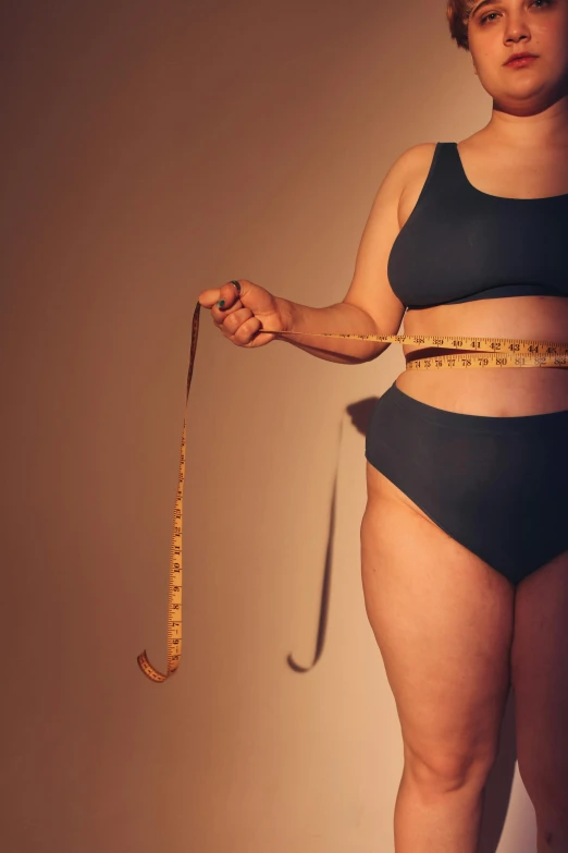 a woman with a measuring tape around her waist, by Arabella Rankin, trending on pexels, a portrait of a plump woman, wearing a tanktop and skirt, thick linings, holding a cane