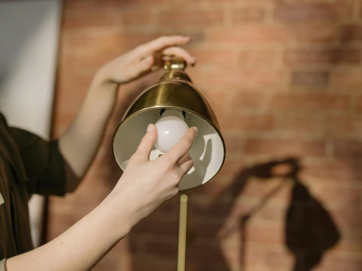 a close up of a person holding a lamp