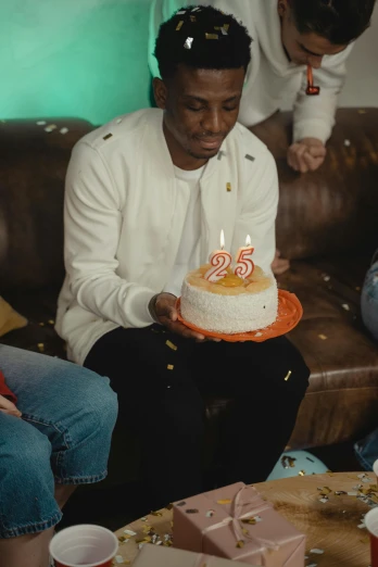 a group of people sitting around a table with a cake, an album cover, pexels, he is about 20 years old | short, david uzochukwu, 2 5 6 x 2 5 6 pixels, pals have a birthday party