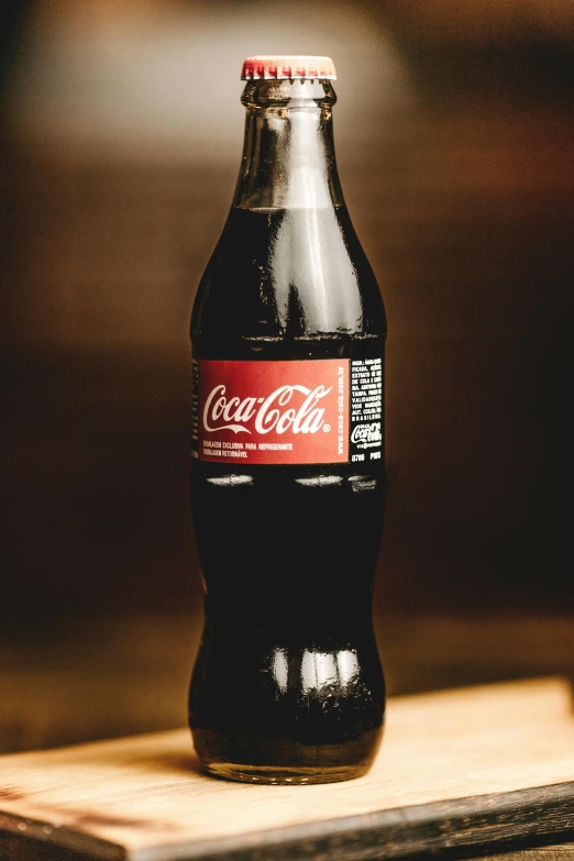 a bottle of coke sitting on top of a wooden table, detailed product image, side profile shot, traditional medium, fan favorite