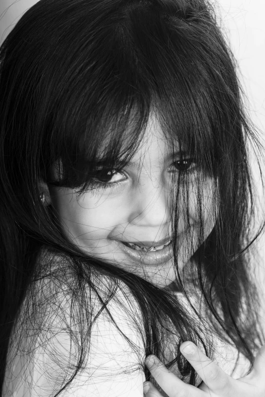 a black and white photo of a girl with long hair, by Altichiero, 5 years old, black bangs, happy smile, ((portrait))