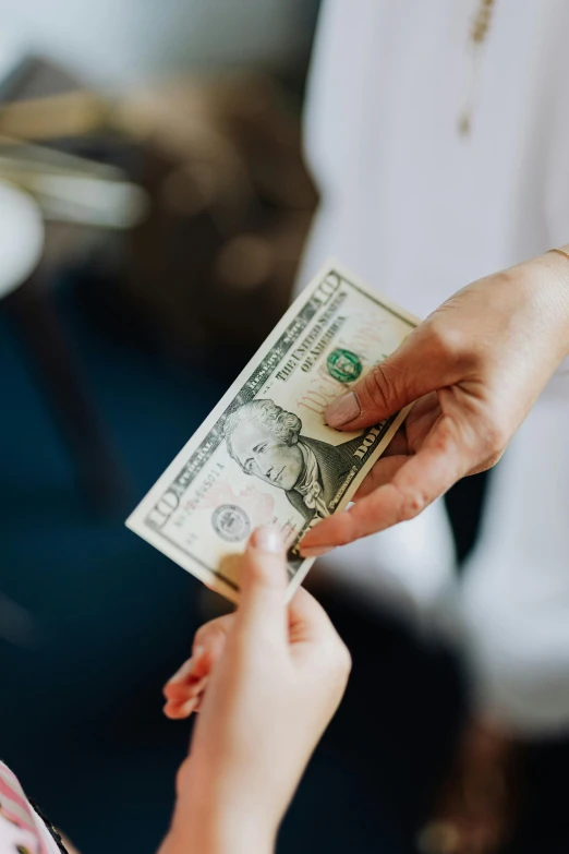 a woman handing a dollar to another woman, by Niko Henrichon, pexels contest winner, loosely cropped, promo image, multiple stories, religious