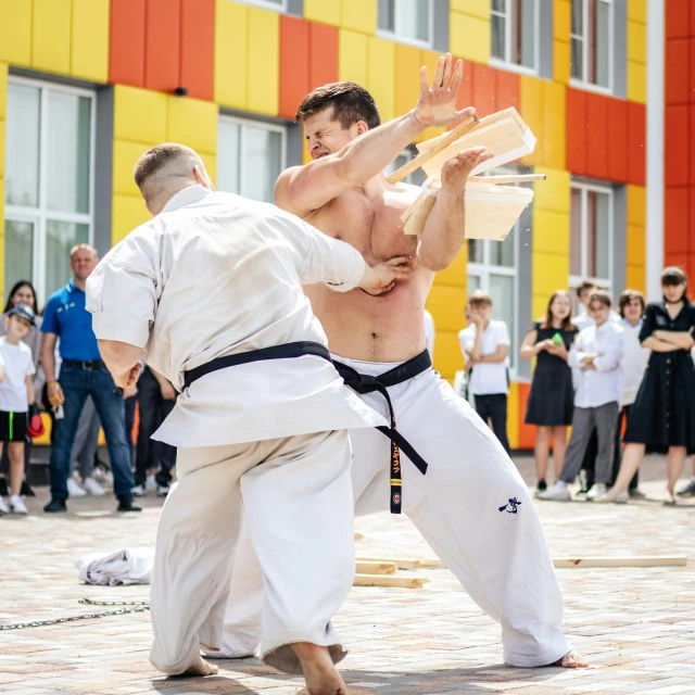 a couple of men standing next to each other on a street, an album cover, by Ilya Ostroukhov, pexels contest winner, figuration libre, martial arts tournament, midsommar style, in an action pose, фото девушка курит