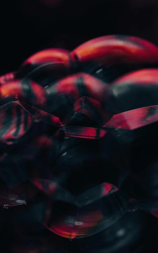 a bunch of wine glasses sitting on top of a table, a microscopic photo, unsplash contest winner, video art, black and red armor, jelly - like texture. photograph, motion graphics, cinematic movie image