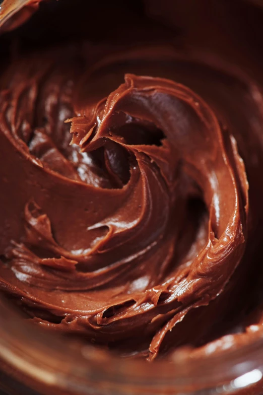 a close up of a bowl of chocolate frosting, inspired by Jan Müller, smooth waxy skin, whirlpool, intense, promo image