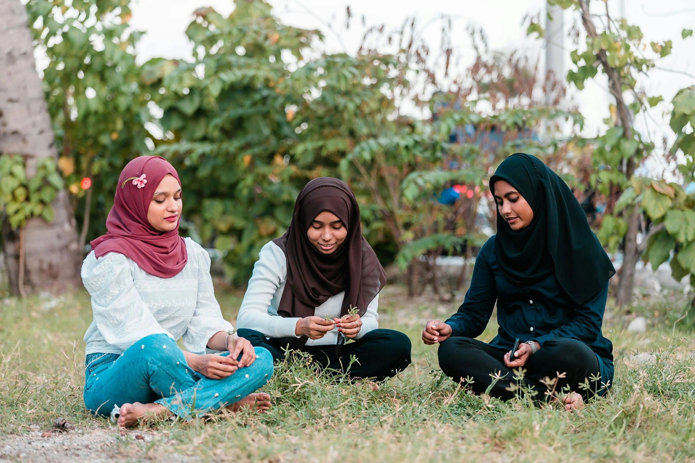 a group of women sitting on top of a grass covered field, by Julia Pishtar, hurufiyya, eating outside, educational, profile image, aida muluneh