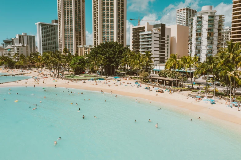 a beach filled with lots of people next to tall buildings, pexels contest winner, hawaii beach, crystal clear blue water, 🦩🪐🐞👩🏻🦳, flat lay