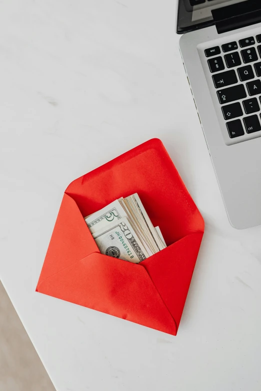 a laptop computer sitting on top of a white table, by Julia Pishtar, private press, dressed in red paper bags, cash, email, modern minimalist f 2 0