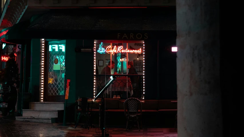 a neon sign on the side of a building, by Elsa Bleda, pexels contest winner, photorealism, sitting alone at a bar, blade runner set, standing in a restaurant, farid ghanbari