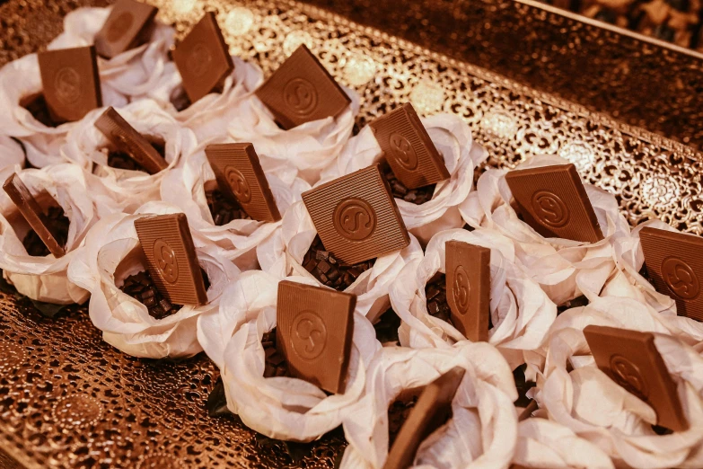 a tray of chocolates sitting on top of a table, gutai group, smokey burnt envelopes, stunning details, ready to eat, engraved