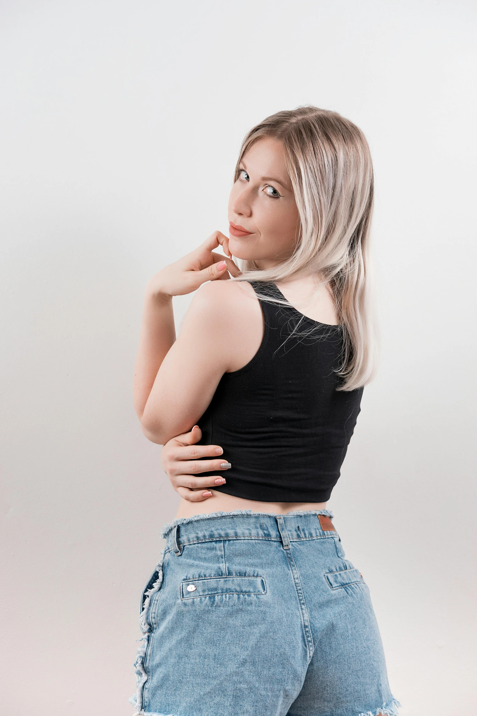 a woman in high waisted jeans posing for a picture, an album cover, by Lucebert, featured on reddit, wearing a cropped black tank top, profile image, clear background, ekaterina