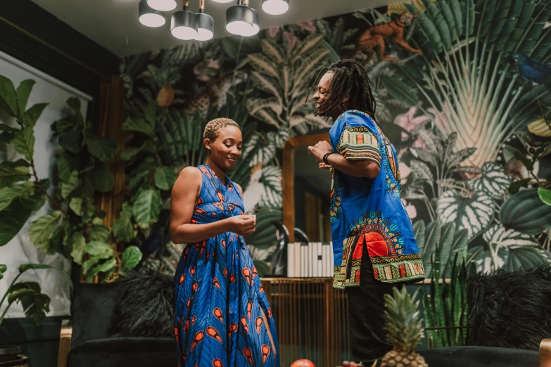 a couple of women standing next to each other in a living room, by Julia Pishtar, pexels contest winner, black arts movement, wearing an african dress, couple dancing, avatar image, lush surroundings