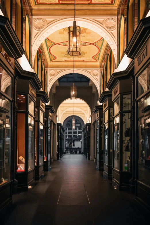 a long hallway with a clock hanging from the ceiling, by Daniel Seghers, renaissance, lots of shops, electricity archs, profile image, burberry