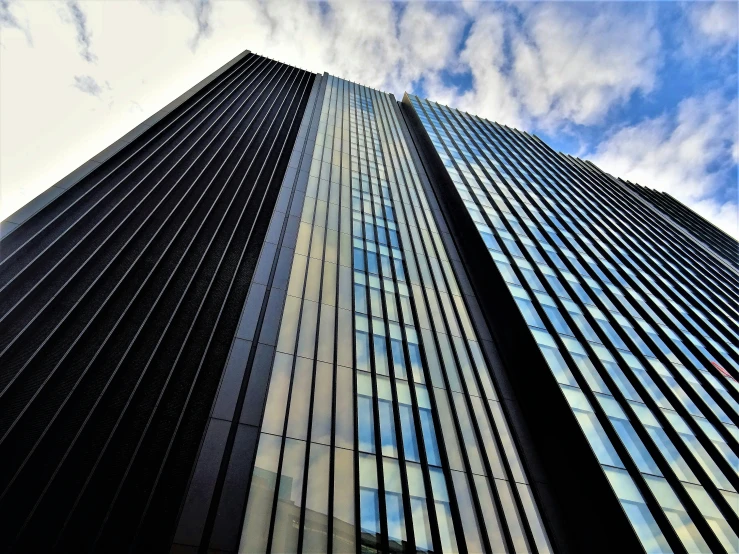 a very tall building with a lot of windows, inspired by Richard Wilson, pexels contest winner, black steel buildings, award winning shading, edge to edge, sins inc skyscraper front