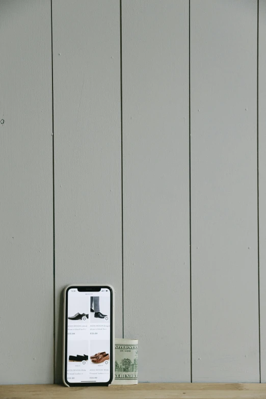 a cell phone sitting on top of a wooden shelf, a picture, by Doug Ohlson, postminimalism, white plank siding, grey mustache, single color, vertical wallpaper