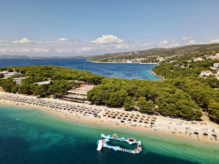 a large body of water next to a beach, croatian coastline, square, resort, laputa