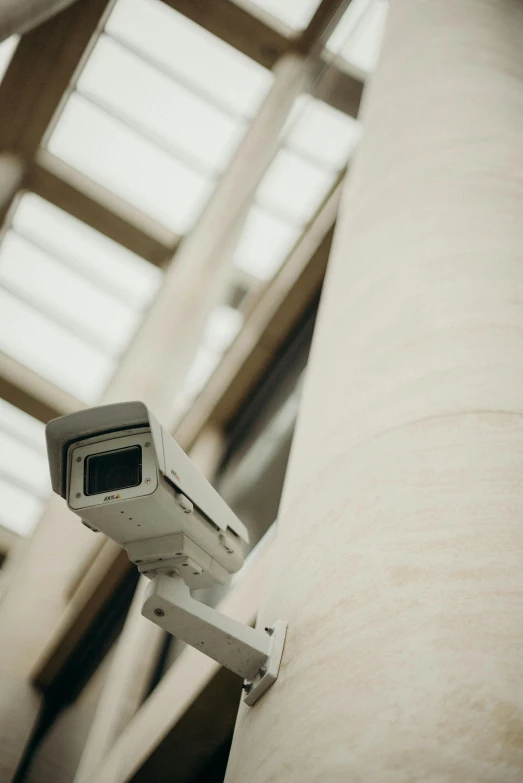 a surveillance camera mounted on the side of a building, by Carey Morris, unsplash, renaissance, 1990s photograph, promo image, historical footage, secuirty cam footage