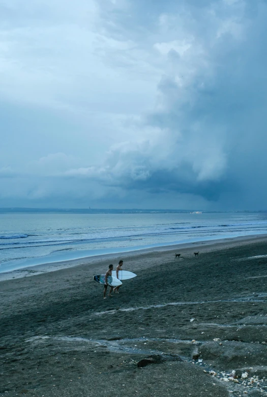 a person walking on a beach with a surfboard, by Adriaen Hanneman, unsplash contest winner, sumatraism, thunderstorm supercell, 2 people, ignant, blue sand