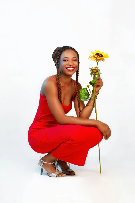 a woman in a red dress holding a sunflower, by Chinwe Chukwuogo-Roy, pexels, renaissance, in front of white back drop, casual pose, sza, 15081959 21121991 01012000 4k