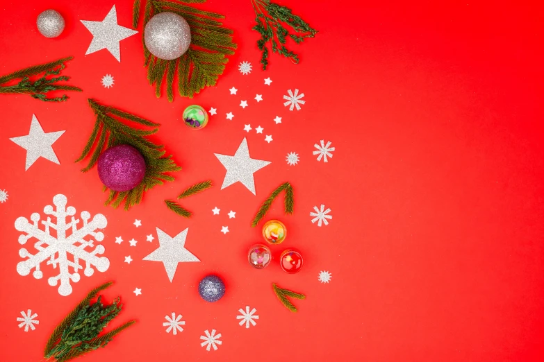 christmas decorations on a red background, pexels contest winner, complementary colour scheme, lots of stars, evergreen branches, bold complementary colours