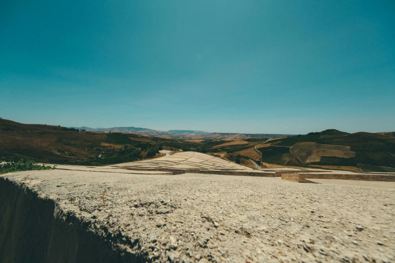 a dirt road with a blue sky in the background, pexels contest winner, les nabis, white travertine terraces, looking onto the horizon, landfill, italian masterpiece