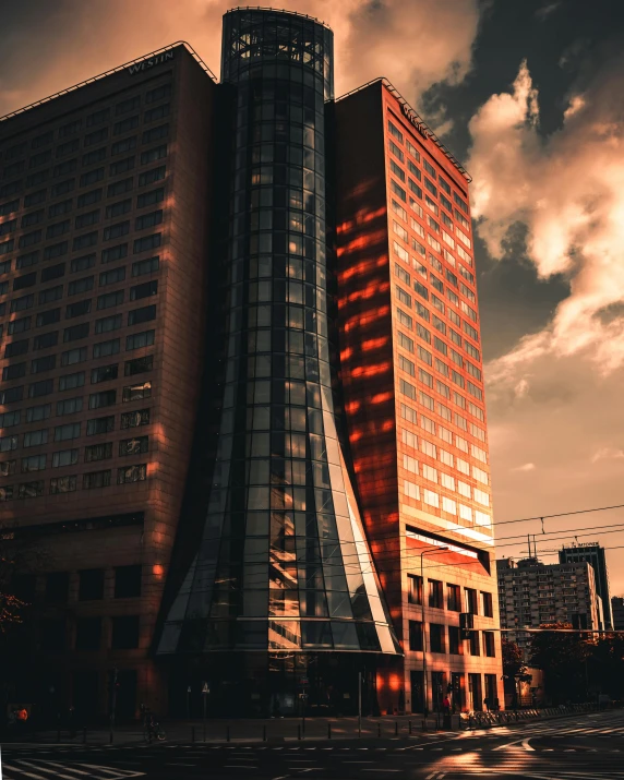 a very tall building sitting in the middle of a city, by Adam Marczyński, pexels contest winner, brutalism, dramatic reddish light, nice afternoon lighting, high quality screenshot, multiple stories