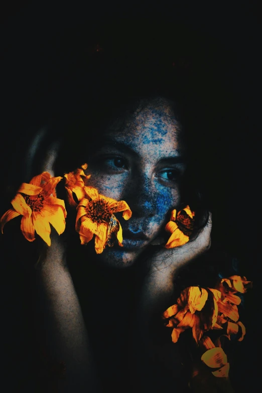 a woman holding flowers in front of her face, inspired by Elsa Bleda, pexels contest winner, beautiful black blue yellow, woman portrait made out of paint, grainy filter, day - glow facepaint