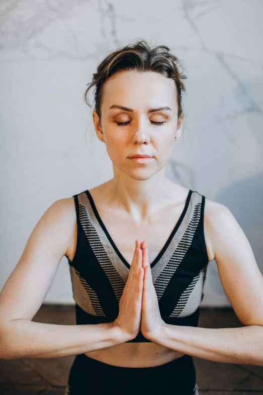 a woman sitting in a yoga position with her eyes closed, a portrait, trending on pexels, renaissance, upper body avatar, low quality photo, religious, centered in image