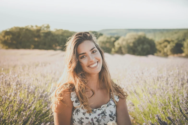 a woman standing in a field of lavender, a picture, happening, genuine smile, avatar image, pokimane, french facial features