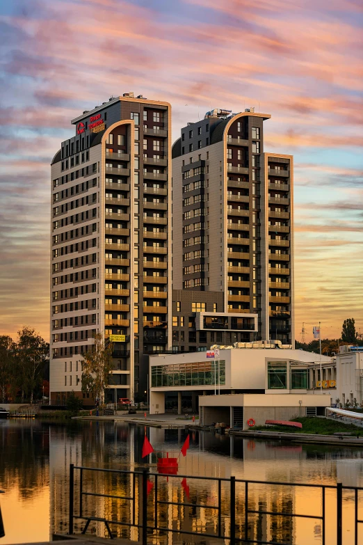 a couple of tall buildings next to a body of water, bauhaus, hotel, helmond, located in hajibektash complex, ivan aivazovski