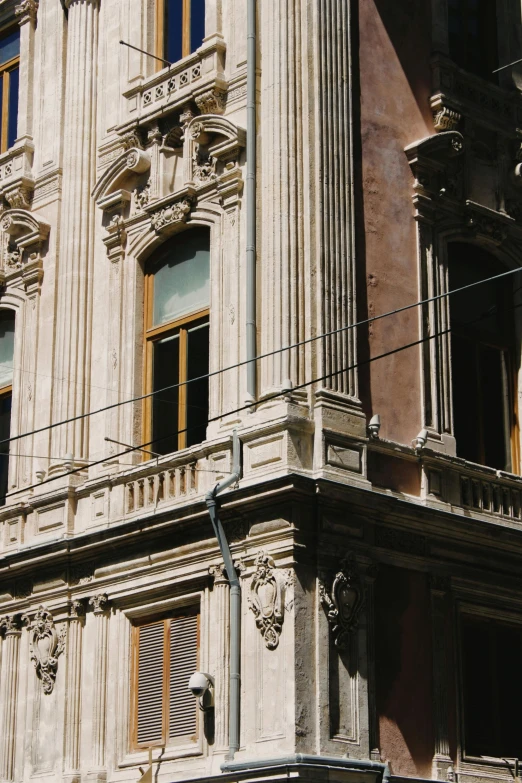 a tall building with a clock on the front of it, inspired by Gianfredo Camesi, neoclassicism, dilapidated houses, cables everywhere, close - up profile, split near the left