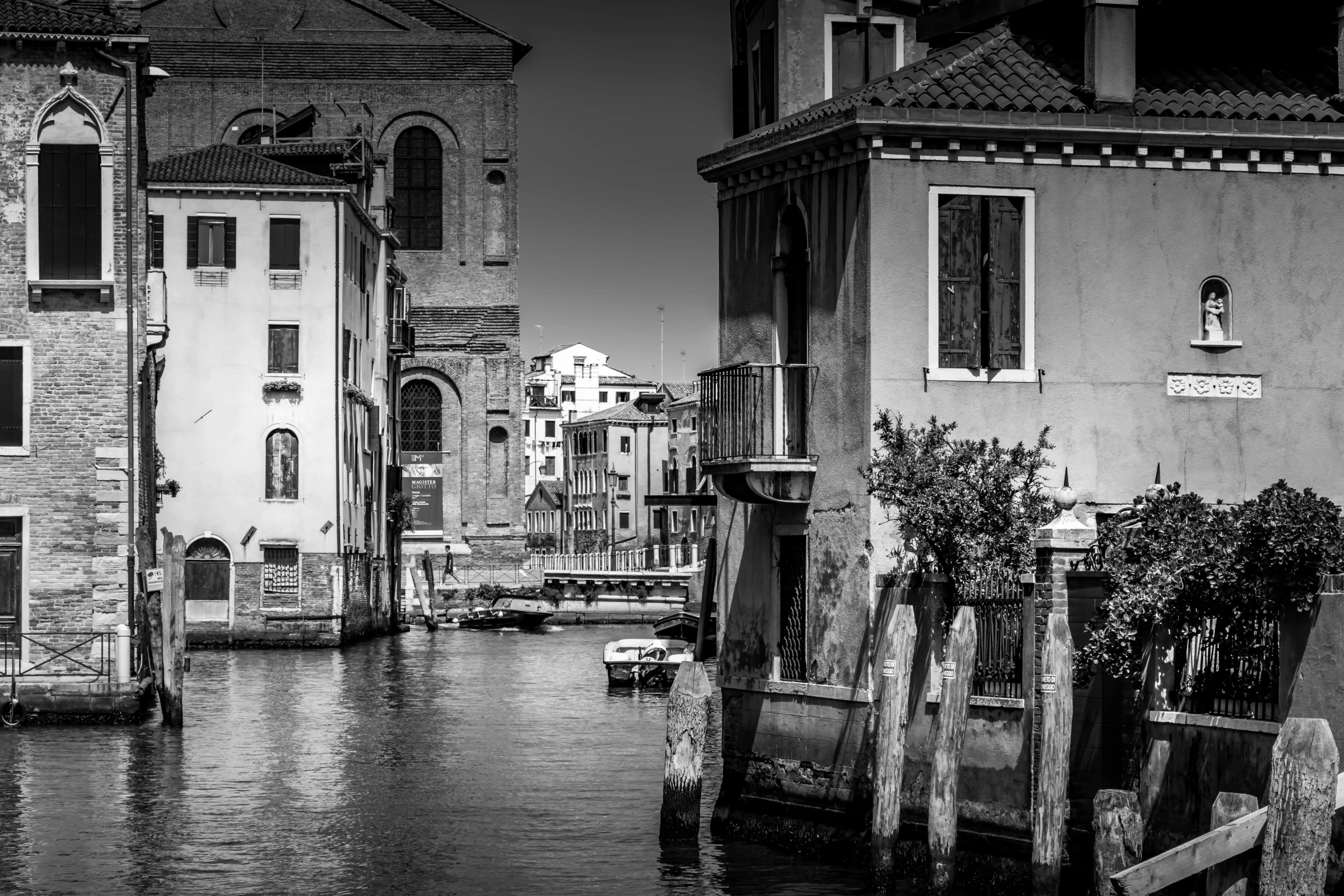 a black and white photo of a canal in venice, a black and white photo, renaissance, wood pier and houses, stefano brunesci, very detailed »