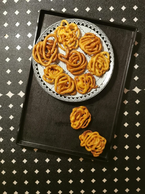 a close up of a plate of food on a table, inspired by Pia Fries, trending on reddit, hurufiyya, spirals, crispy buns, rosette, 33mm photo