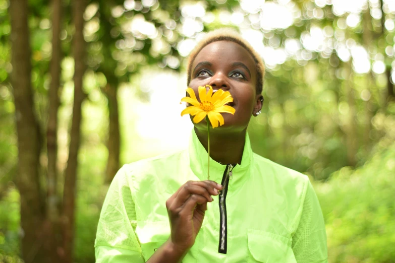 a woman with a yellow flower in her mouth, pexels contest winner, adut akech, lush green, various posed, ( ( dark skin ) )