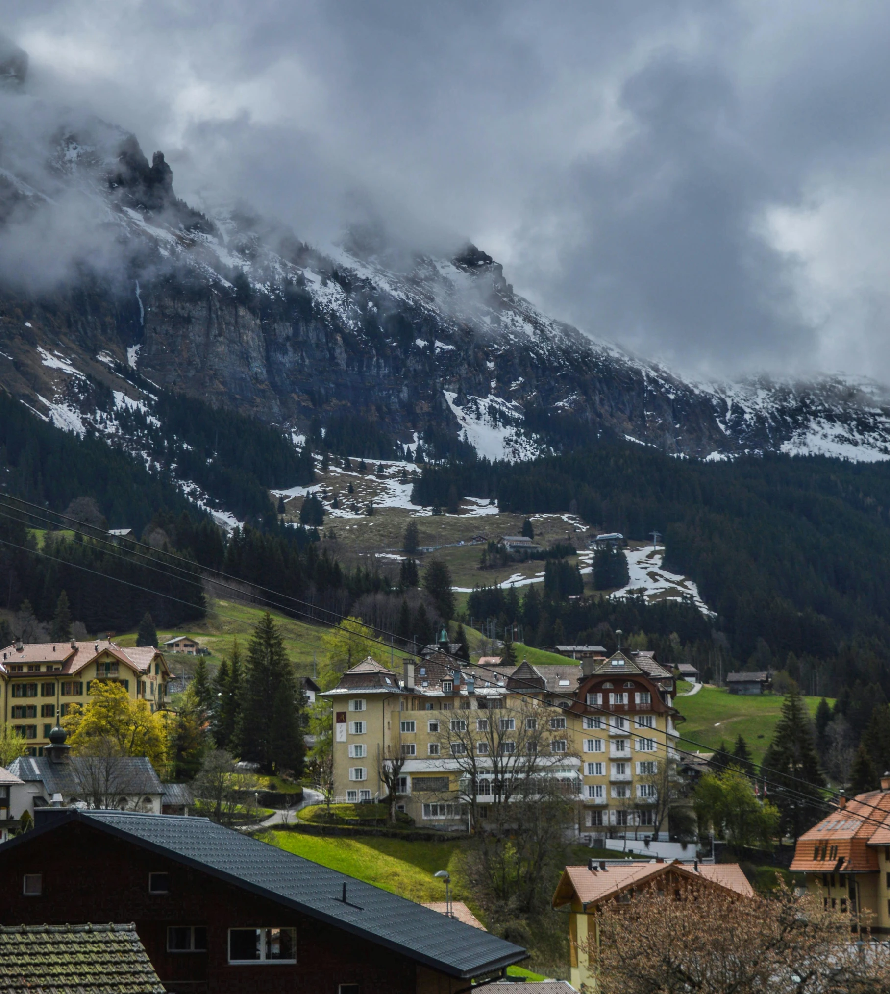 a view of a village with mountains in the background, by Sebastian Spreng, pexels contest winner, renaissance, mountain snow, suzanne engelberg, built on a steep hill, swiss modernizm