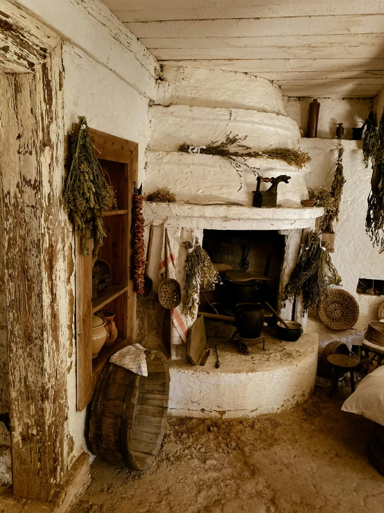 a living room filled with furniture and a fire place, inspired by Jacob Maris, pexels contest winner, renaissance, dried herbs, whitewashed buildings, inside primitive hut, slide show