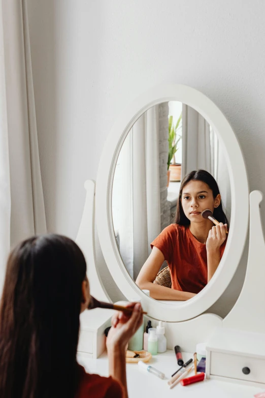 a woman brushes her teeth in front of a mirror, pexels contest winner, romanticism, avatar image, pokimane, oval face, wearing eye shadow