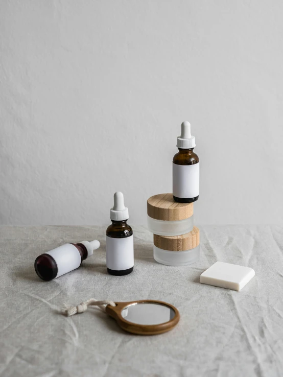 a table topped with bottles of essential oils and a pair of scissors, by Rebecca Horn, 4 k product photo, porcelain organic, vanilla, product view