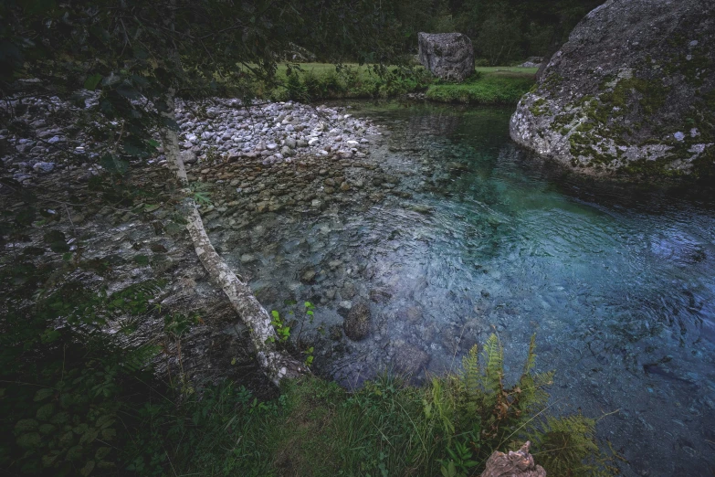 a river running through a lush green forest, an album cover, unsplash contest winner, hurufiyya, crystal clear blue water, alessio albi, rock pools, summer evening