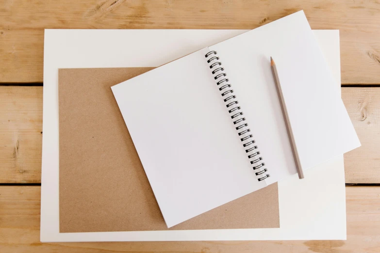 a notepad with a pencil sitting on top of it, a drawing, trending on unsplash, square lines, brown and white color scheme, whiteboards, handcrafted